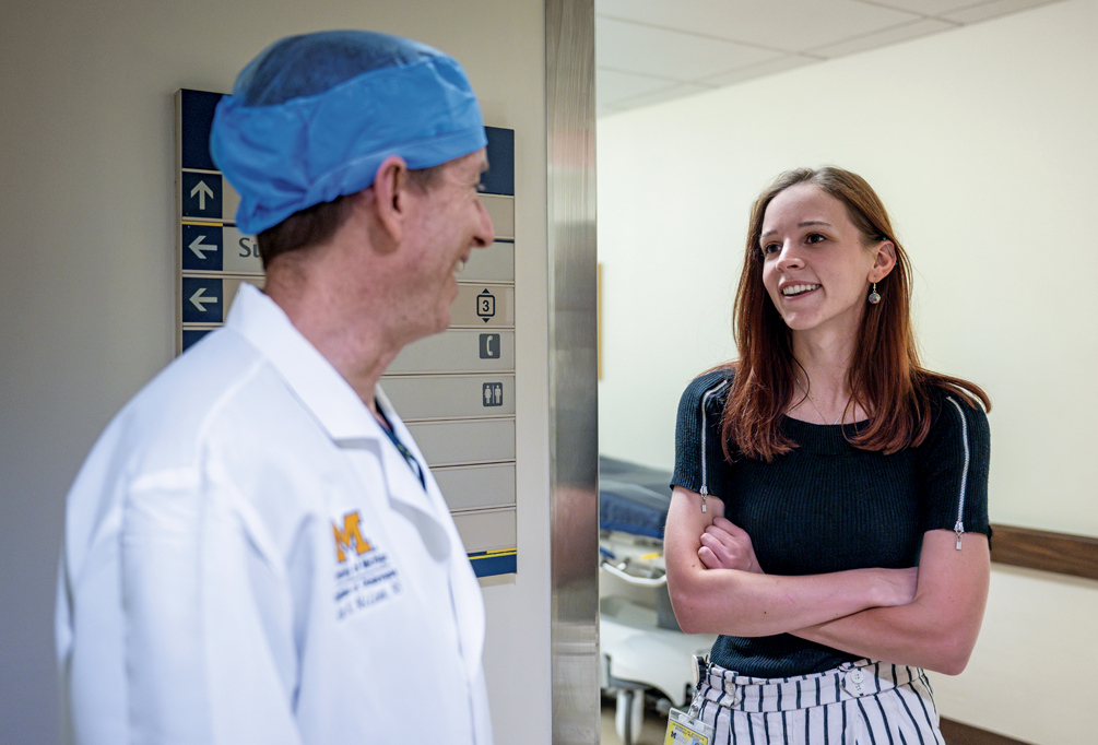 London Kozlowski, right, stops to talk with Dr. Scott McLean on her way to the Department of Anesthesiology at Michigan Medicine. 