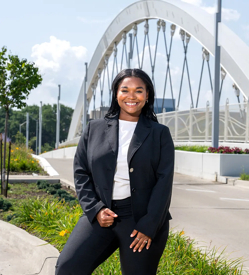 Jessica Holloway stands in front of the 2nd Avenue bridge over the Edsel Ford Freeway near the Henry Ford Health building in Detroit.
