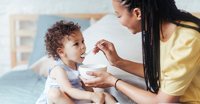 A mother feeding a child