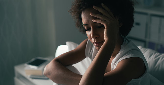 African American woman looking somber.