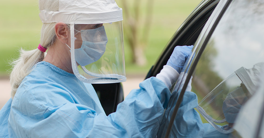 Someone receiving a COVID-19 test in a car.