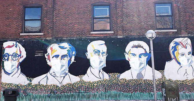 Building mural of men wearing face masks