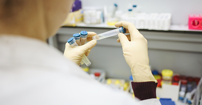 woman holding test tube in lab