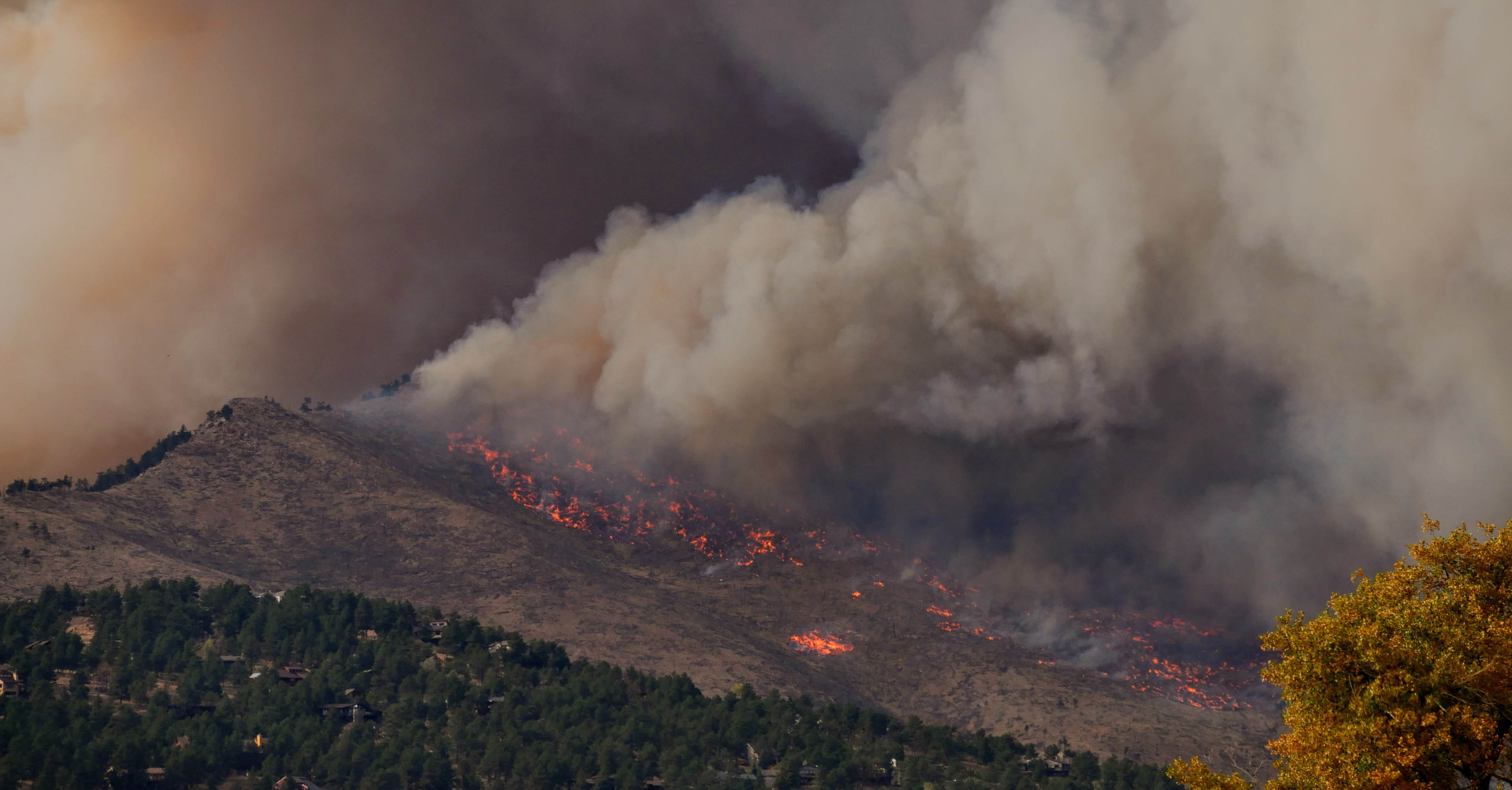 A wildfire spreading down a mountain.