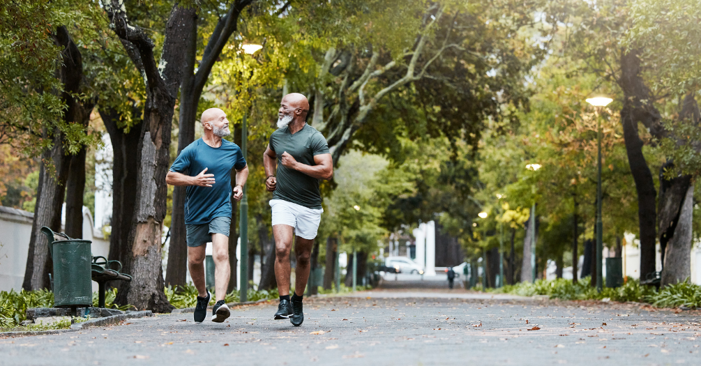 Two senior men enjoy a run outdoors.