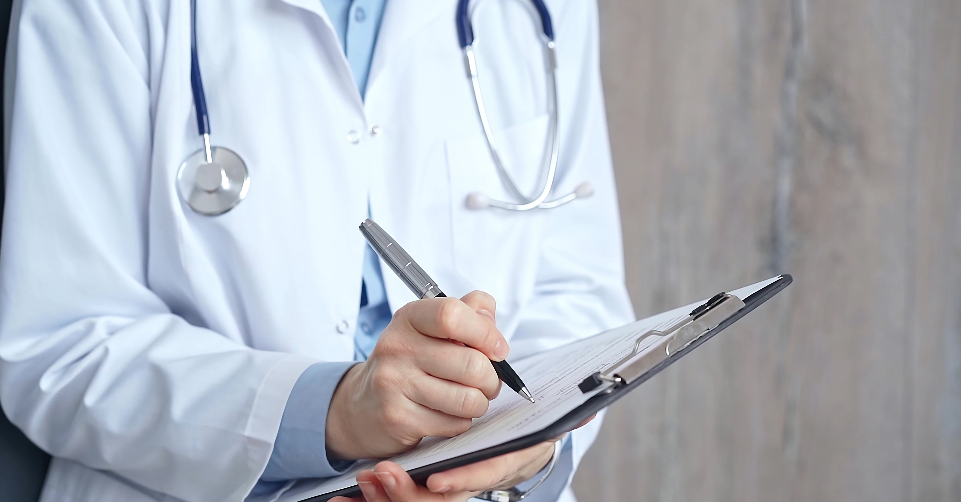 A medical professional holding a clipboard.
