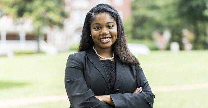 Headshot of Janae Best in a black suit