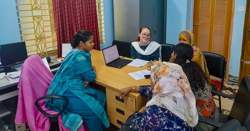 Allison Baumgartner, middle, talks about maternal health with members of the Bangladesh community.